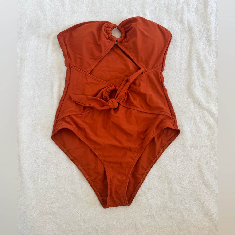 Size medium 1 Piece bathing suit. New condition/Never worn. Rust color strapless